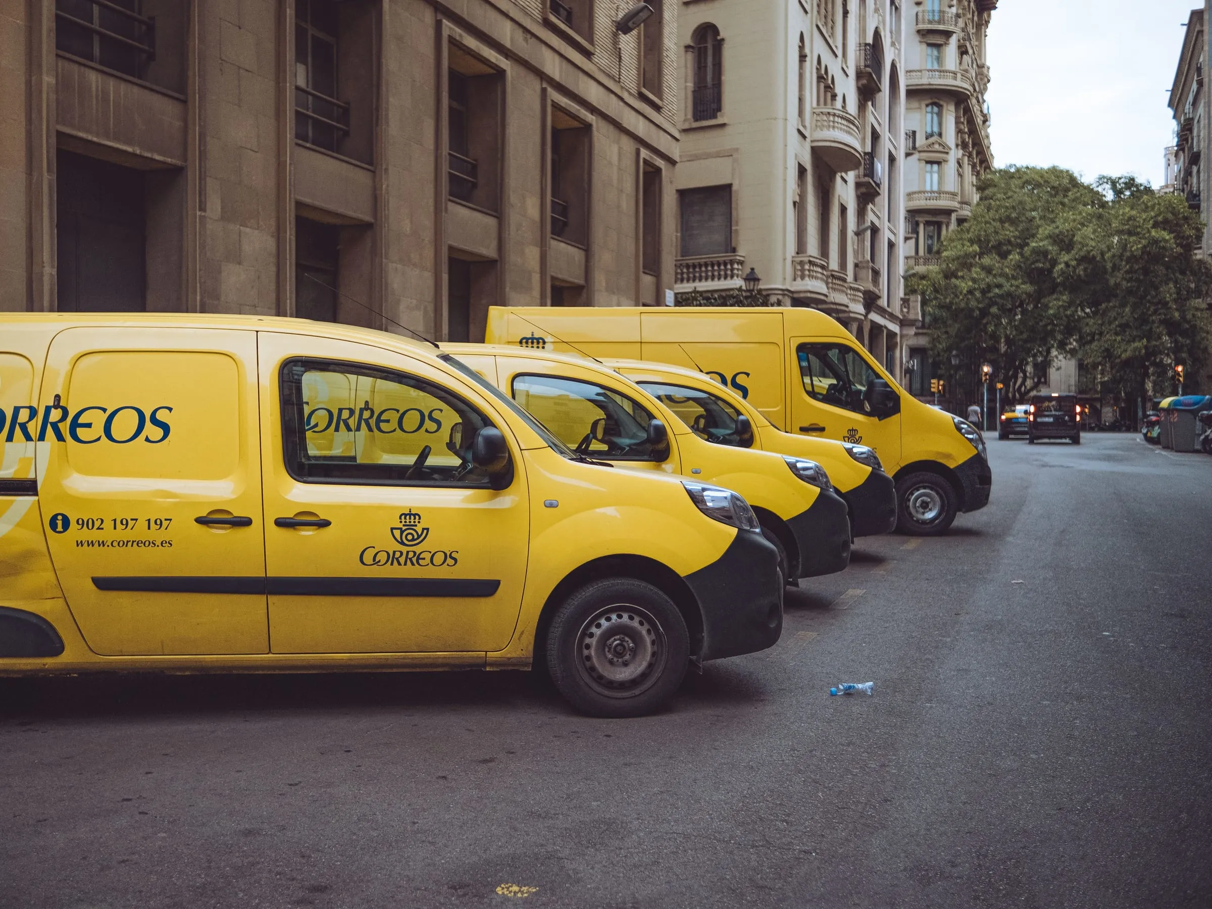Delivery courier vans parked along a city street, ready for same-day routes through the metro.
