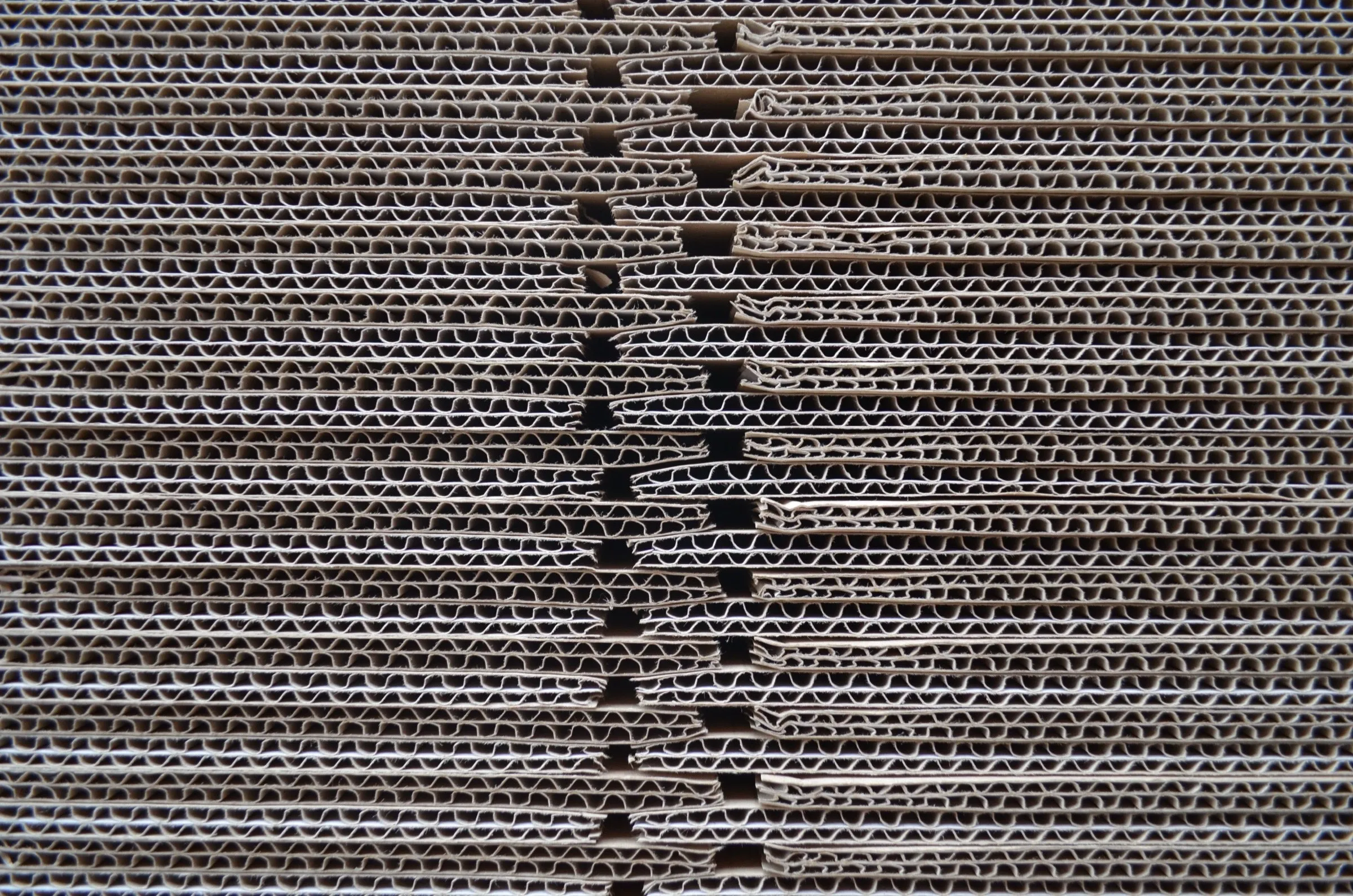 Stacks of new corrugated cardboard shipping boxes ready for packing.