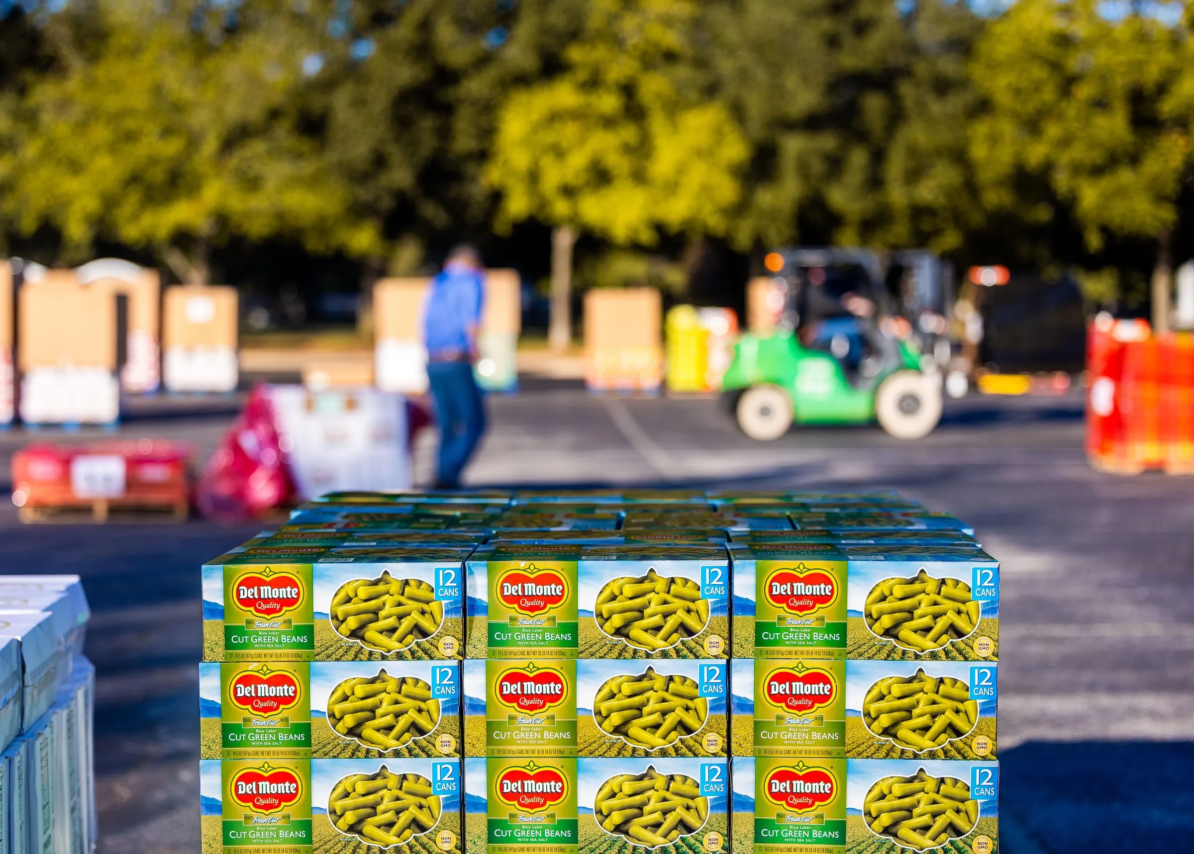 Pallets of canned and packaged goods staged at a refrigerated distribution center, ready for temperature-controlled transport.